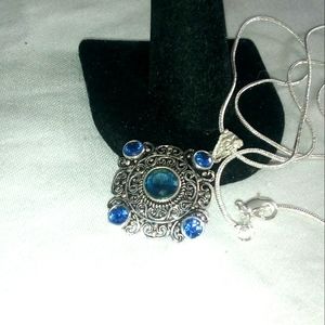 Petite blue sapphire pendant on 20 inch Chain